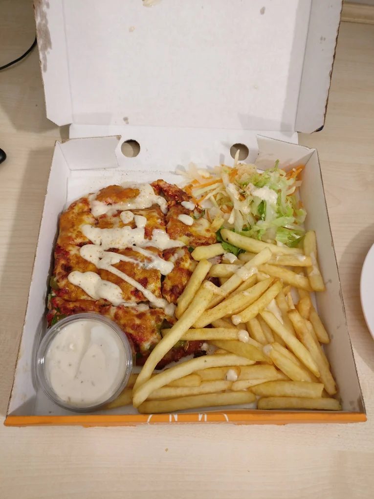 Chicken parmesan with chips, salad and garlic mayo in a box